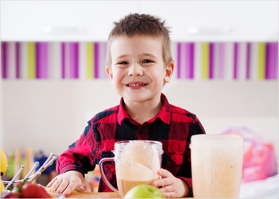 Young boy drinking a smoothie.