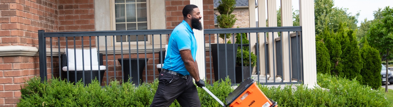 In this banner image, a man is holding a 'Volia box and walking somewhere with it.