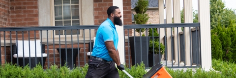 In this banner image, a man is holding a 'Volia box and walking somewhere with it.