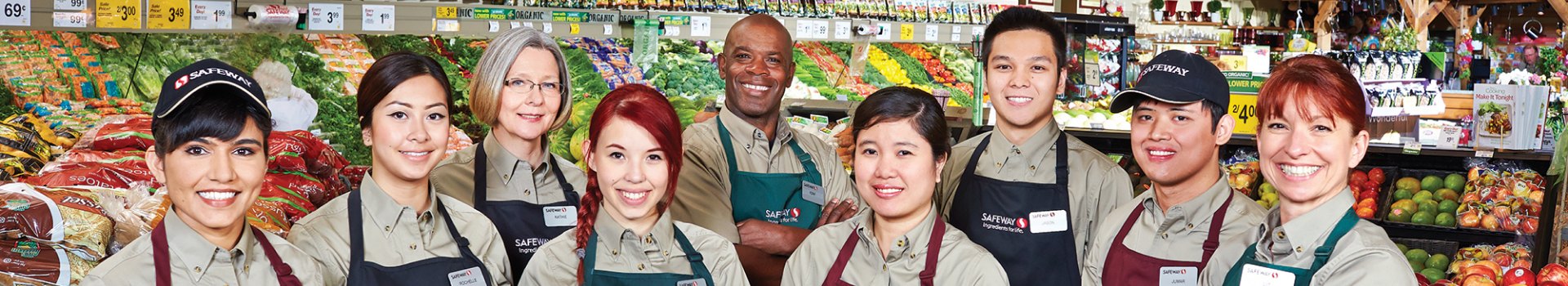 In this image, a group of Safeway employees standing and posing together for a photo.